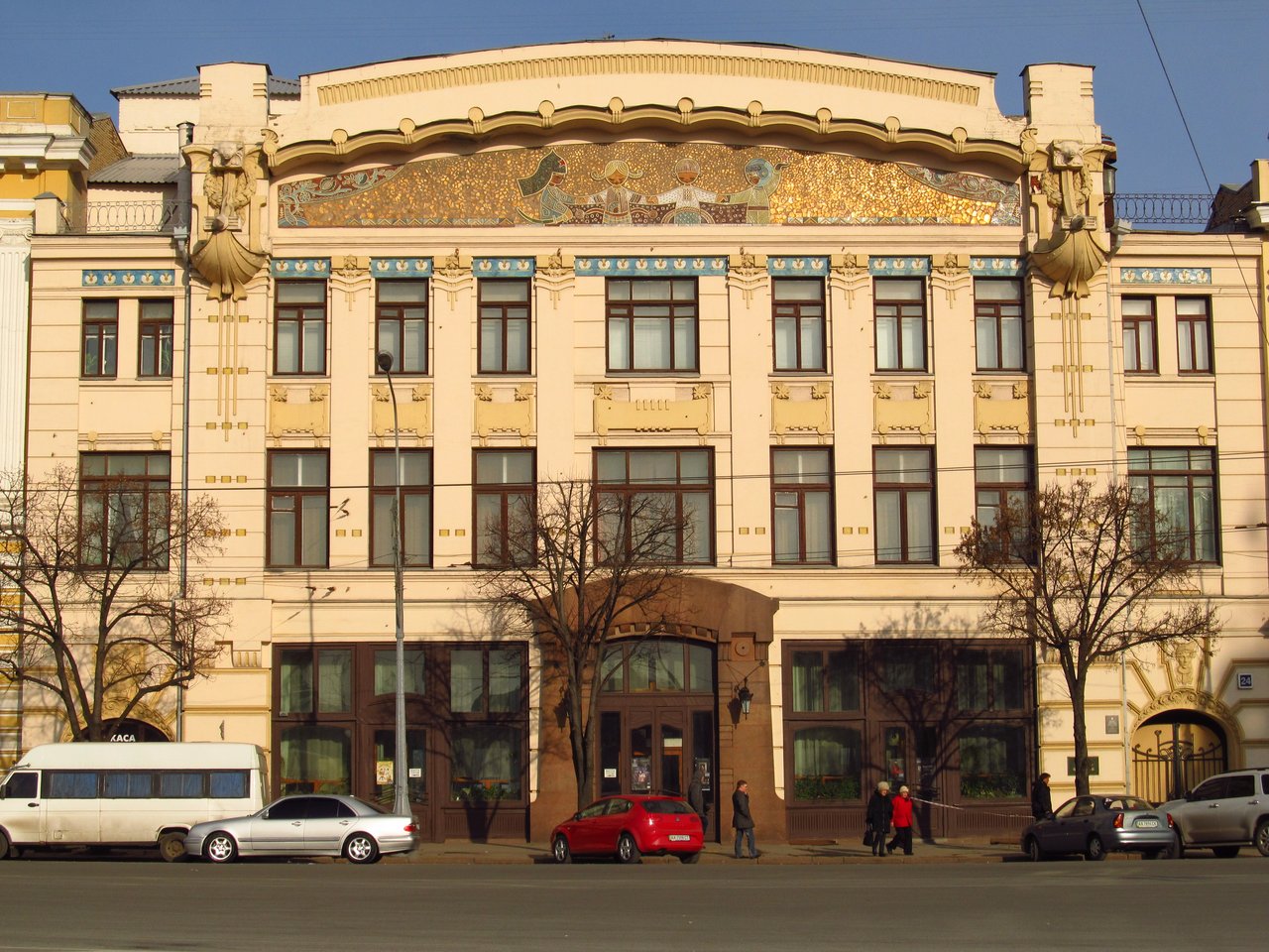 The theater building features bright architecture with decorative elements.