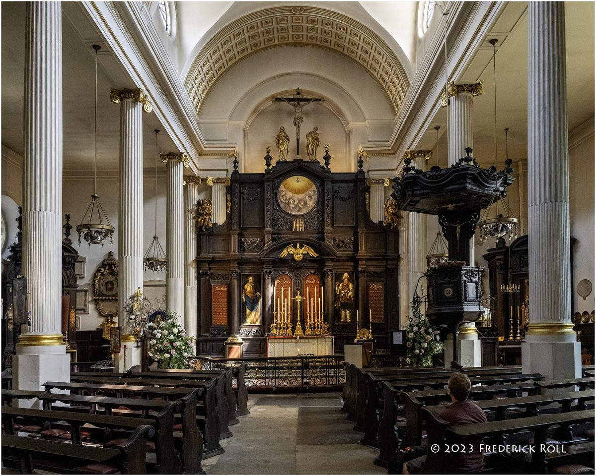 The interior features an altar with intricate carvings and floral arrangements.