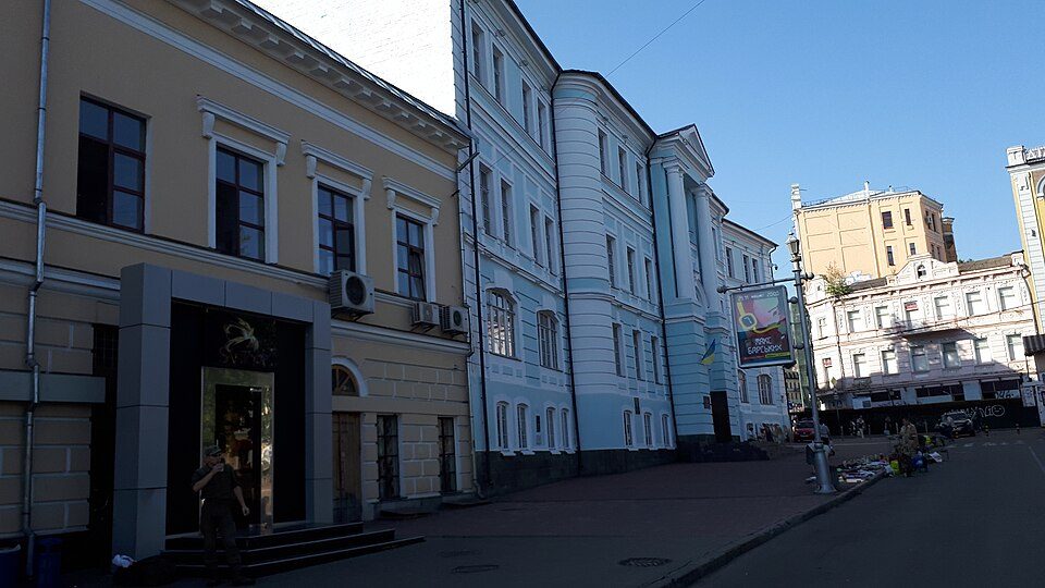 The building features colorful facades and is located on a street in Kyiv.